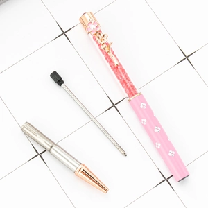 Pink crystal ballpoint pen with rose gold flower clip and rhinestone-filled barrel