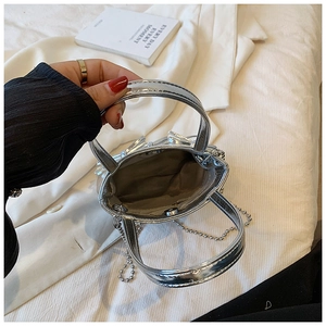 Top-down view of the silver mini handbag interior with metal chain and smooth finish