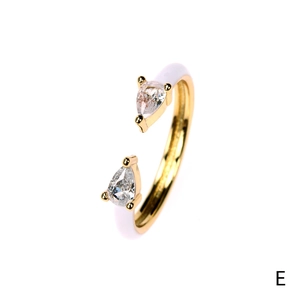Detail of 18K gold plated open ring with white enamel and pear-cut cubic zirconia