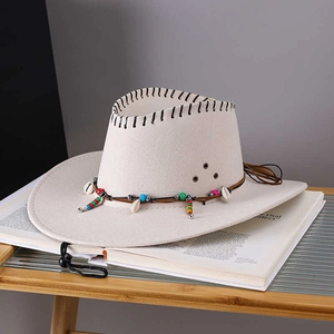 Beige western cowboy hat with shell beads and woven leather strap on magazine