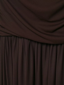 Detail of cross-pleated dark brown fabric with fine vertical pleats on a casual dress