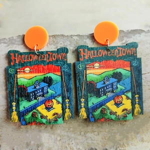 Close-up of Halloween acrylic earrings featuring pumpkin and Halloweentown designs