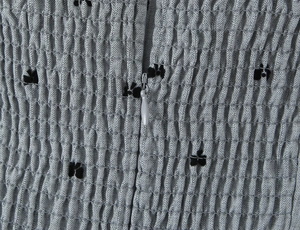 Detail of floral smocked fabric with a concealed zipper closure on a French style dress