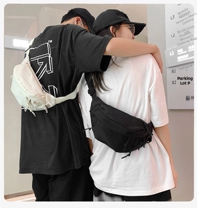 Close-up of street style nylon chest bags in black and beige with zipper details