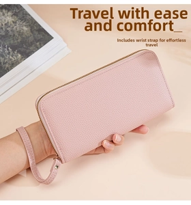 Close-up of pink litchi grain leather long wallet with zipper and wrist strap