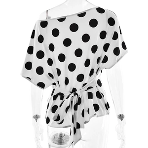 Detail of white one-shoulder polka dot top featuring a stylish waist tie bow detail