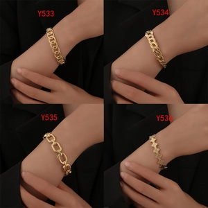 Close-up of four luxury gold-plated titanium steel chain bracelets with various link styles