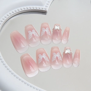 Pink cat eye coffin press-on nails with silver butterfly charms and 3D bow art