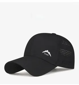 Detail of black sporty cap showing laser-cut ventilation holes and mountain print