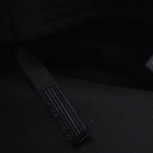 Detail of adjustable black velcro strap and stitching on wool beret for custom fit