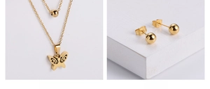 Detail of gold double-layer butterfly pendant necklace and round bead stud earrings