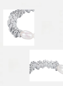 Macro shot of 925 sterling silver spiral band with white oval pearl detail