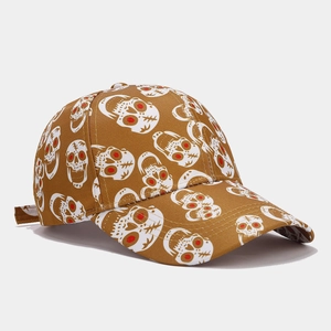 Close-up of the detailed red-eyed skull print on the brown fabric of the baseball cap