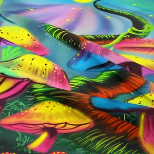 Close-up of psychedelic mushroom tapestry showing detailed woven texture and vibrant neon prints
