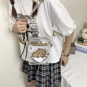 Detailed shot of transparent PVC square bag featuring cute cartoon capybara and duck prints