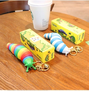 Rainbow and blue-white finger slug fidget toys with golden keychains and bells