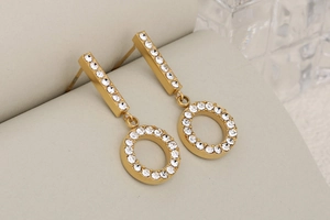 Macro shot of gold-plated geometric earrings with sparkling pavé cubic zirconia