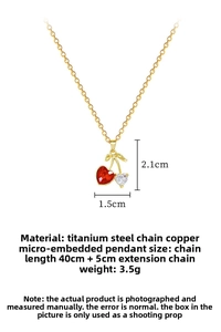 Detail of cherry pendant with red faceted gem and heart zircon on gold chain