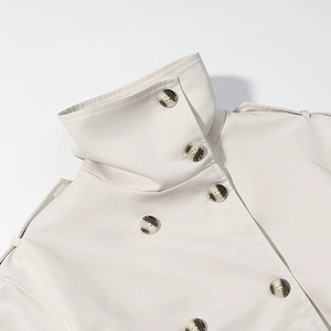 Detail of high stand collar and shoulder epaulettes on a double-breasted trench coat