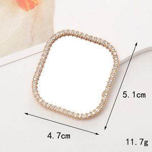 Detail view of a square gold mirror accessory with rhinestones and size measurements