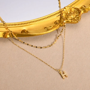 Gold double-layered stainless steel necklace with a sparkling pavé crystal letter H pendant