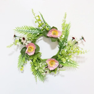 Top view of a floral wreath with pink poppies, white daisies and green fern leaves