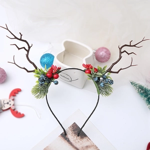 Detail view of festive Christmas headband with brown reindeer antlers and red berries