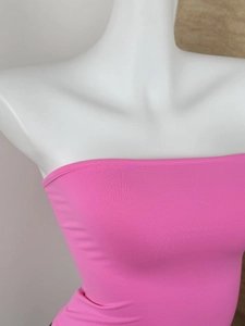 Detailed close-up of bright pink elastic bandeau top showing seamless fabric texture