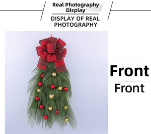 Close-up of Christmas wreath with red and black buffalo plaid bow and festive ornaments