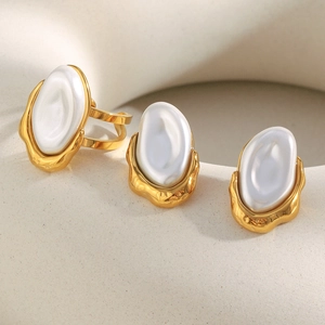 Close-up of 18K gold plated Baroque pearl earrings and open ring jewelry set