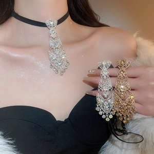 Macro shot of rhinestone tie tassel choker necklace in gold and silver finish