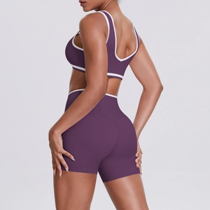 Detailed view of purple yoga set featuring ergonomic fit and white contrast binding edges