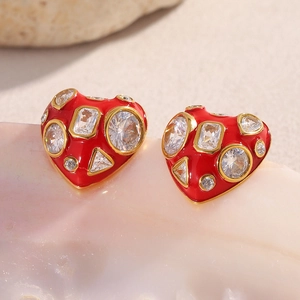 Detailed macro view of 18K gold plated red enamel heart studs with sparkling zircons