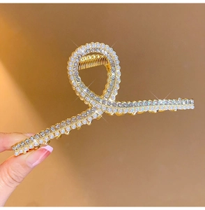 Close-up of 11cm luxury metal hair claw clip with pearls and sparkling rhinestones