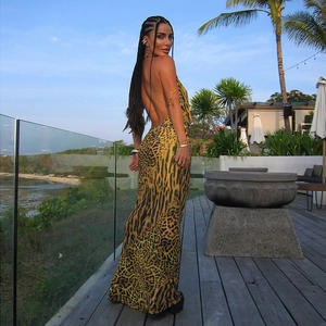 Detail of the leopard print maxi dress with open back design on a female model outdoors