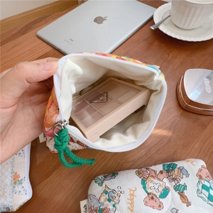 Detailed interior of a floral quilted cotton makeup bag with green rope handle