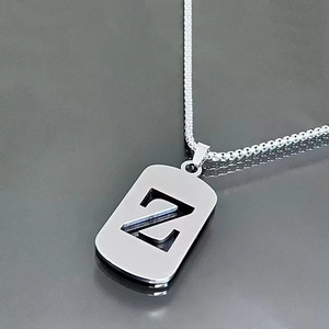 Macro shot of a silver letter Z pendant on a sleek titanium steel chain necklace