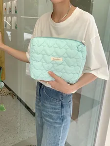 Mint green quilted heart pattern makeup bag with zipper and Sorakka brand label