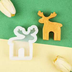 Detailed view of translucent deer silicone mold alongside finished golden elk sculpture