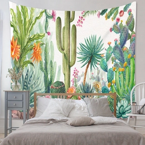 Detail of bohemian wall tapestry featuring hand-painted desert plants and cactus in a bedroom