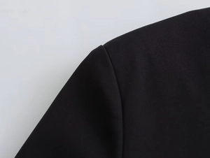 Close-up of shoulder seam and high-quality stitching on a black casual fashion jacket