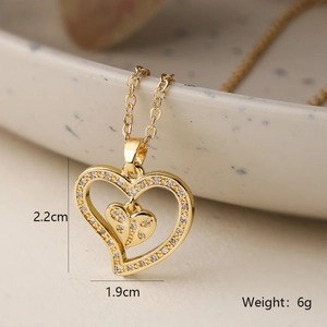 Detail of gold heart pendant with zircon inlay showing dimensions 2.2cm and 1.9cm