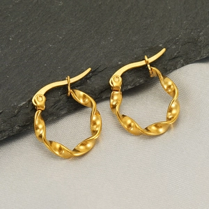 Chic 18k gold-plated stainless steel twisted hoop earrings on stone and fabric background
