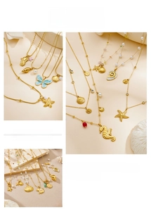 Detailed shot of gold-plated sea shell and starfish pendants with colorful beads