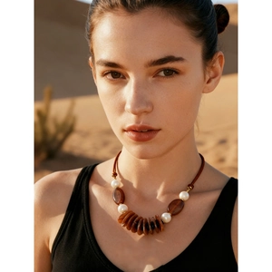 Boho leather necklace with layered acrylic oval pendants and brown beads on a model