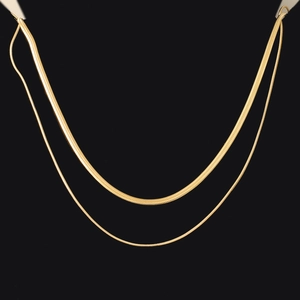 Detailed view of layered gold snake chains showing texture and dual-strand hip-hop design