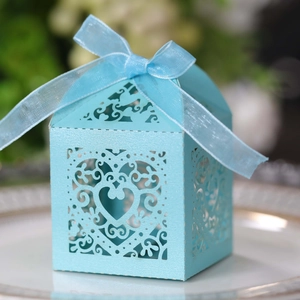 Sky blue heart-shaped laser-cut gift box with silk ribbon bow and intricate patterns