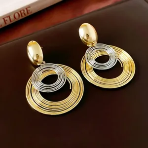 Minimalist coiled geometric metal earrings in gold and silver finish for women