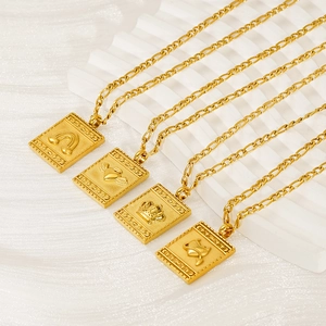 Detailed relief of rainbow, winged heart, and crown on gold pendants with Figaro chain