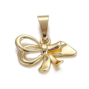 Macro shot of 3D gold bow pendant accessory showing metallic luster and small hanging loop
